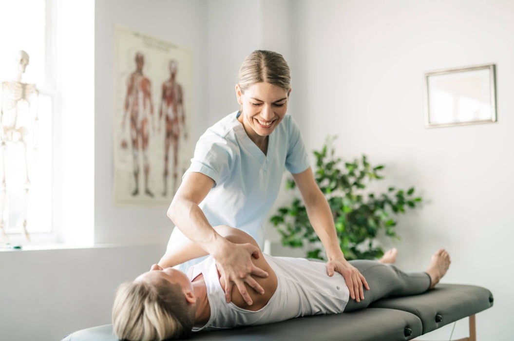 A Modern rehabilitation physiotherapy worker with woman client